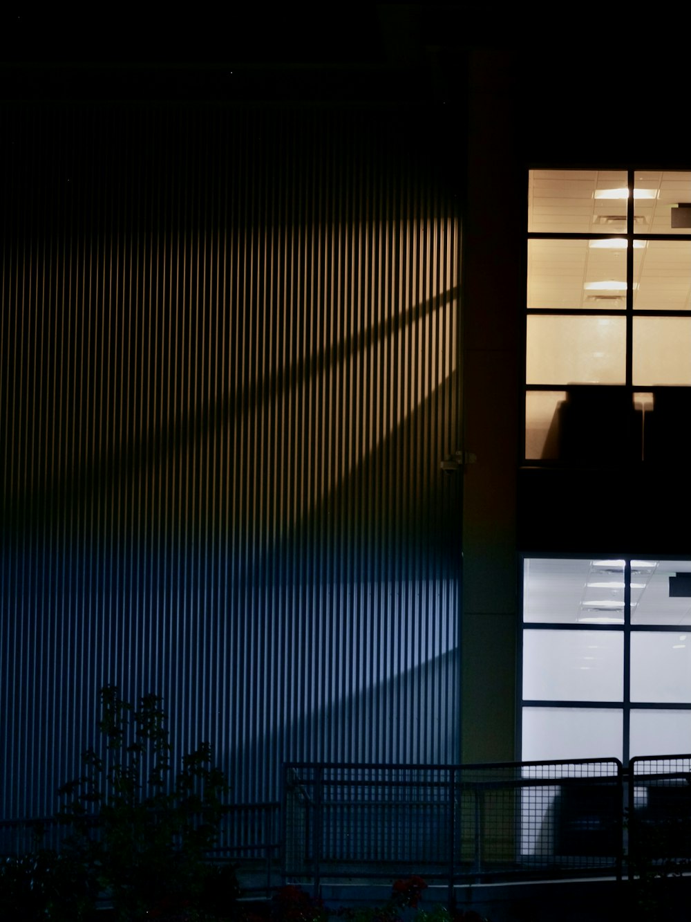 a person standing in front of a window at night