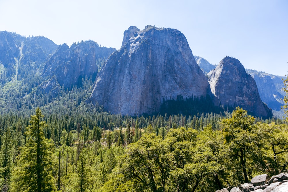 a view of a mountain range with trees and mountains in the background