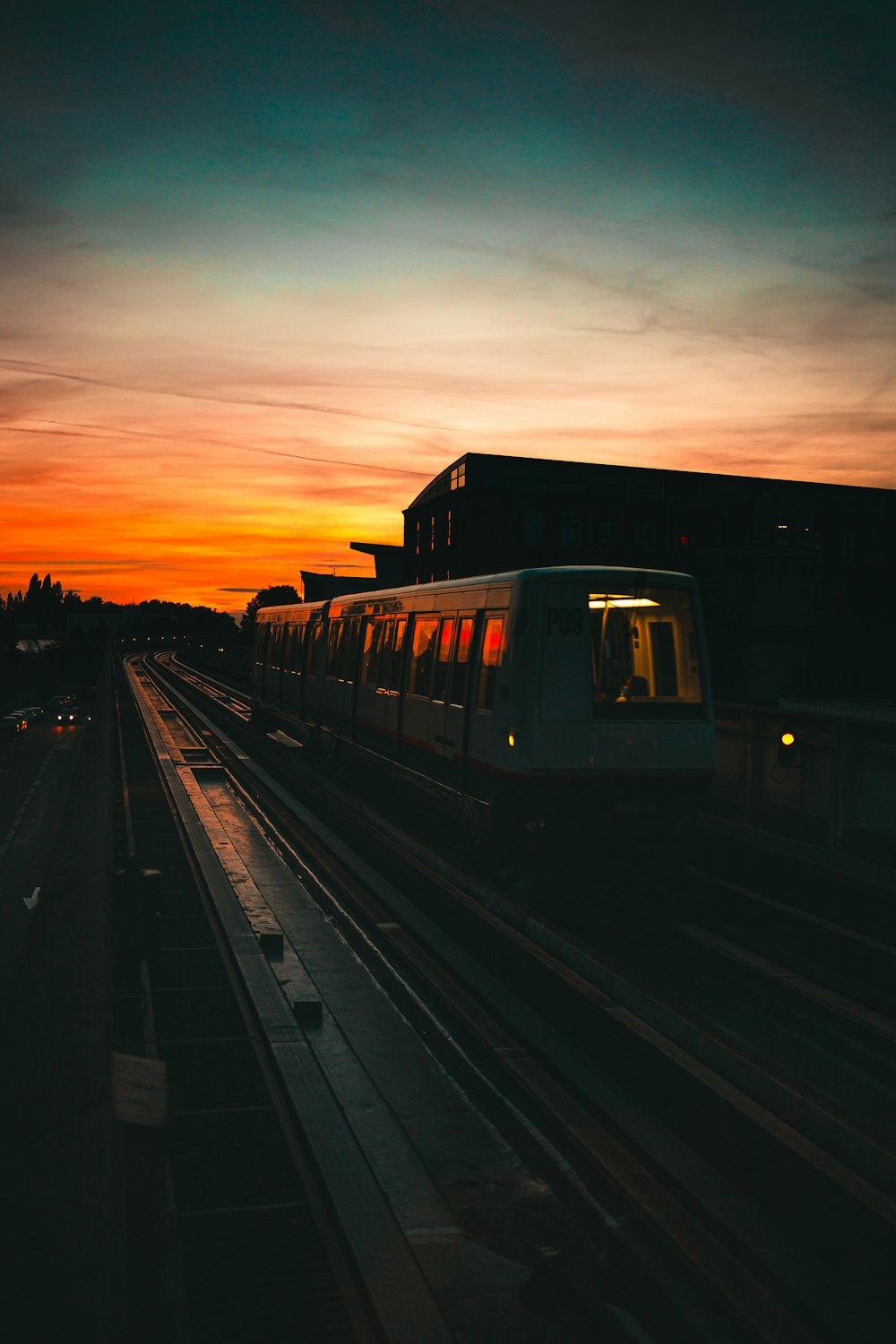 a train traveling down train tracks at sunset