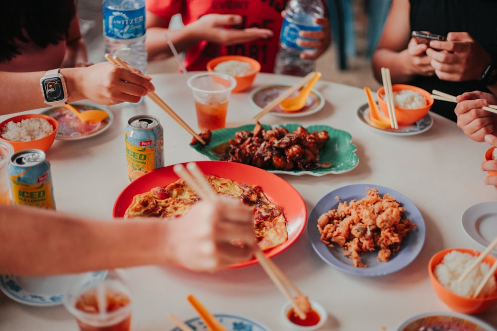 a group of people sitting around a table eating food