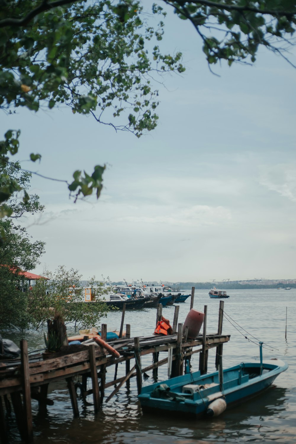 a small blue boat sitting on top of a body of water