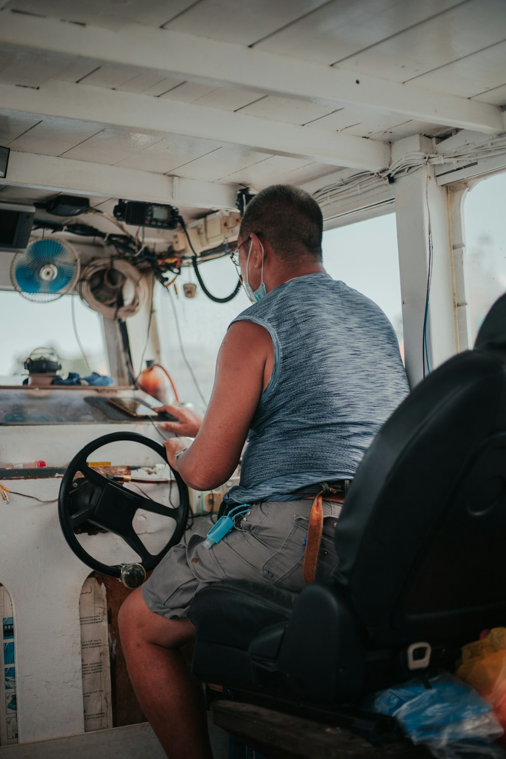 a man driving a boat on a body of water