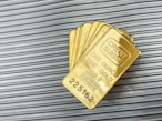 a group of gold cards sitting on top of a metal wall