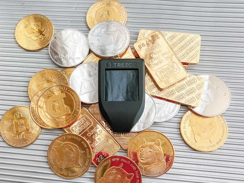 a cell phone sitting on top of a pile of coins