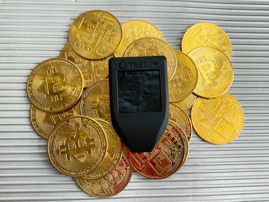 a cell phone sitting on top of a pile of gold coins