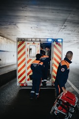 a couple of men standing next to an ambulance