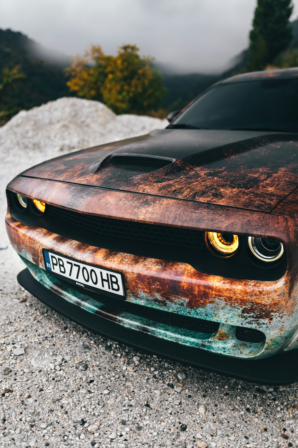 a car that is sitting on some rocks