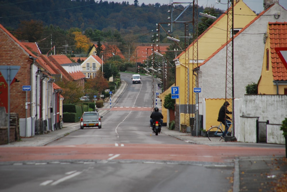 a person riding a motorcycle down a street