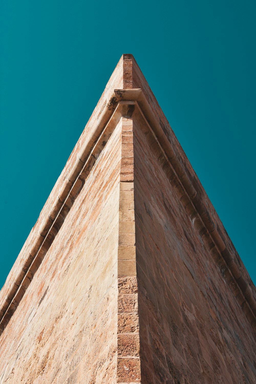 the corner of a building with a blue sky in the background