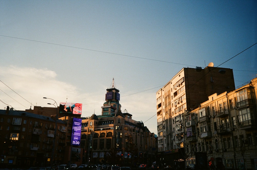 a city street filled with traffic next to tall buildings