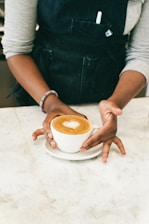 a woman is holding a cup of coffee