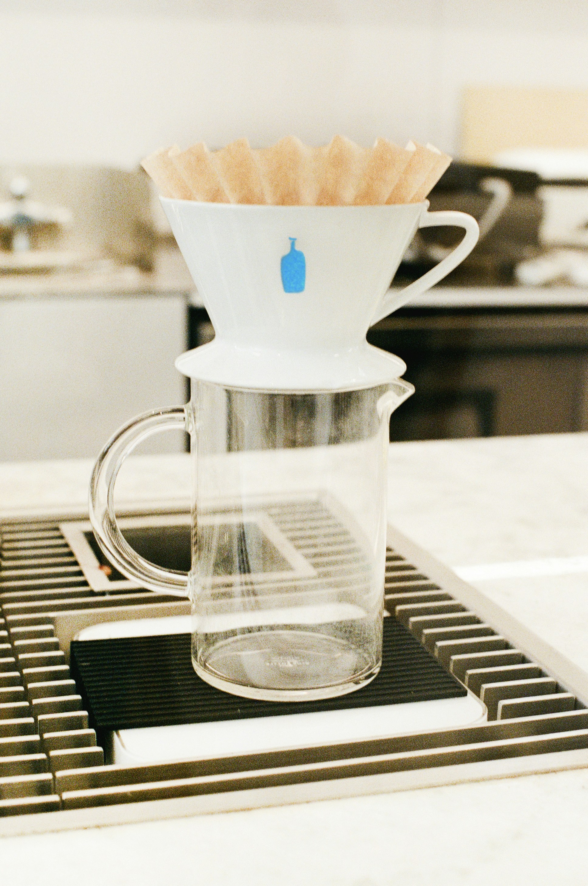 a glass pitcher filled with french fries on top of a stove