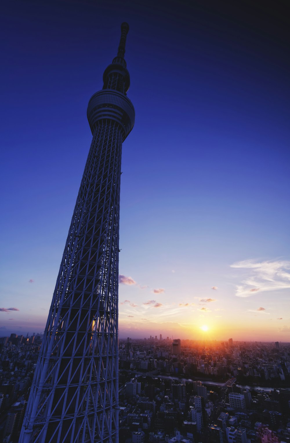 a very tall tower with a sunset in the background