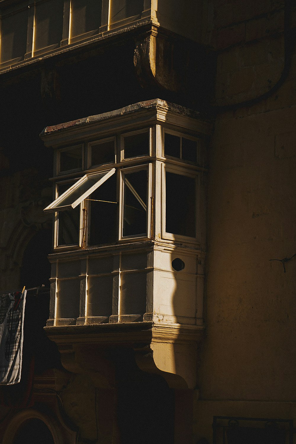 an old building with a window and a balcony