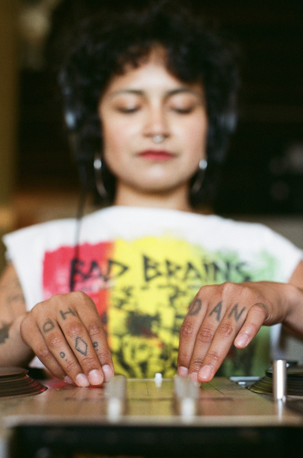 a woman with headphones on playing a dj's turntable