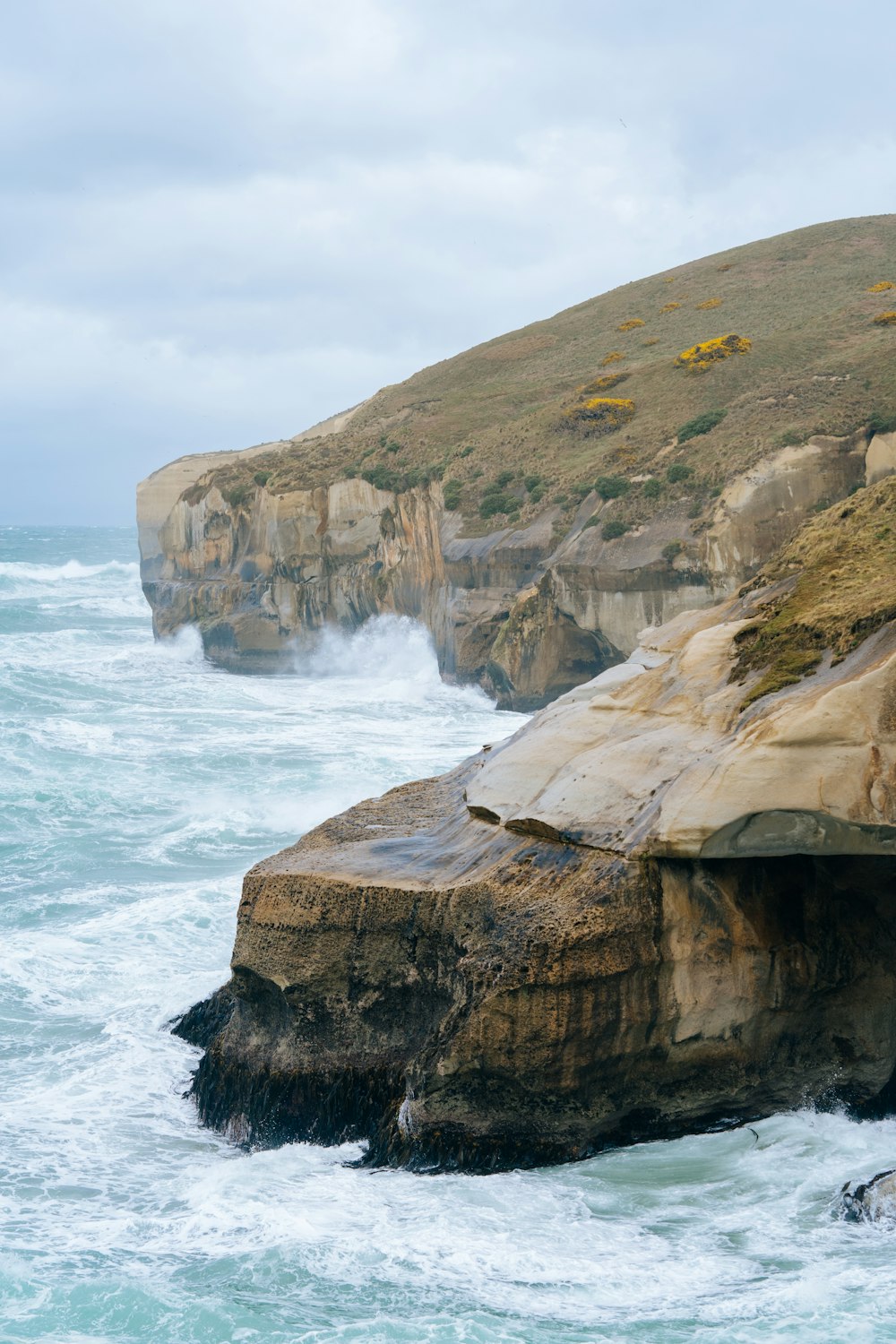 a rocky cliff overlooks a body of water