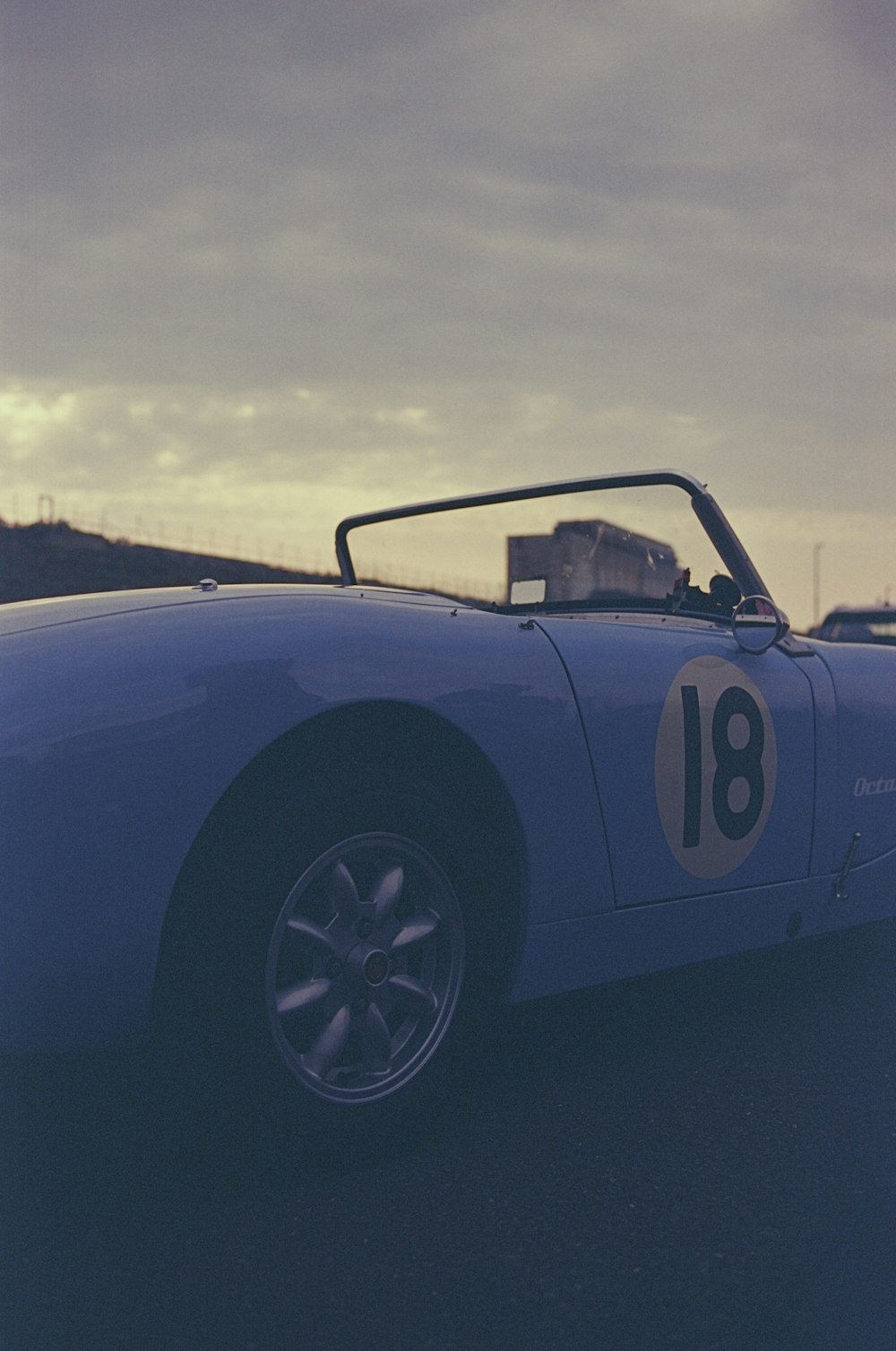 a blue sports car parked on the side of the road