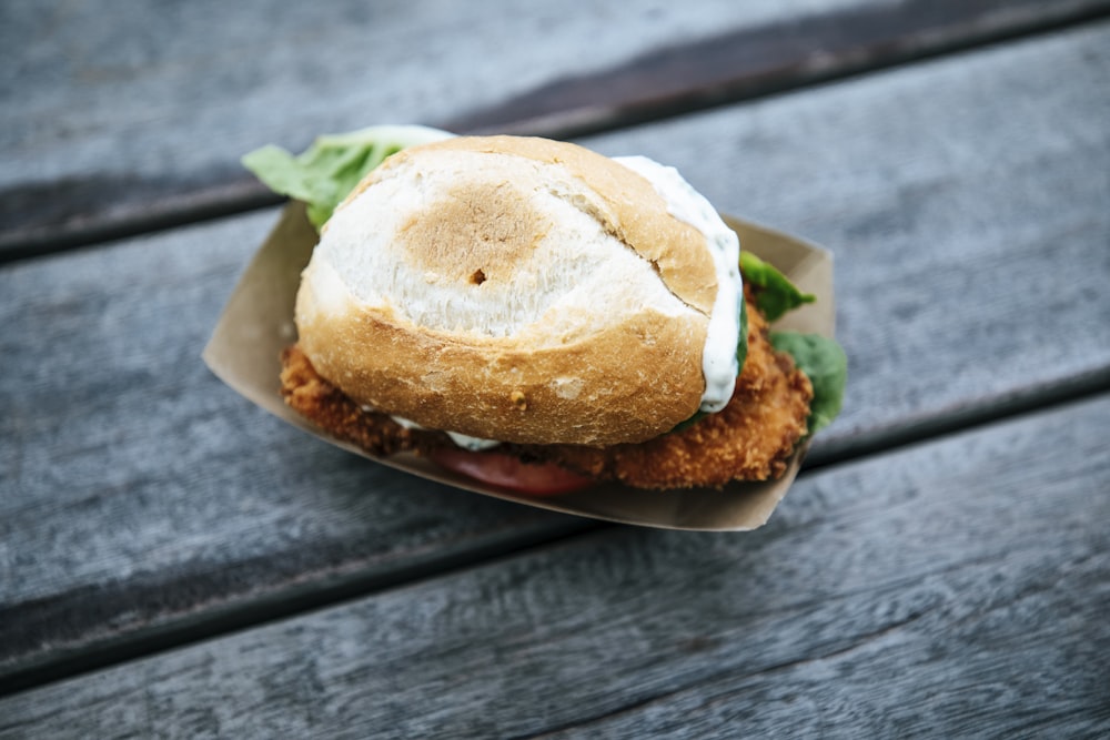 a fried chicken sandwich on a wooden table