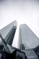 a couple of tall buildings sitting next to each other