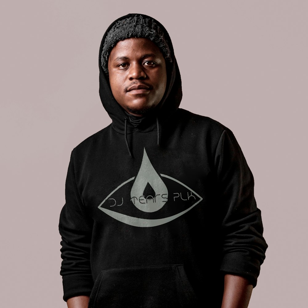 a man wearing a black hoodie with an eye on it