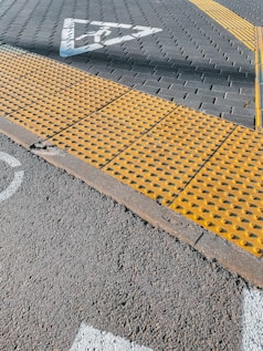 a yellow stop sign sitting on the side of a road