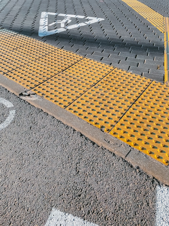 a yellow stop sign sitting on the side of a road