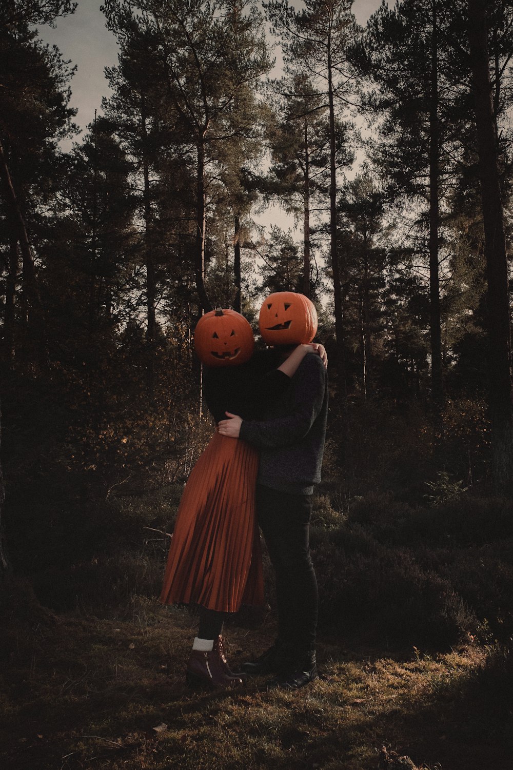 a couple hugging each other in the woods