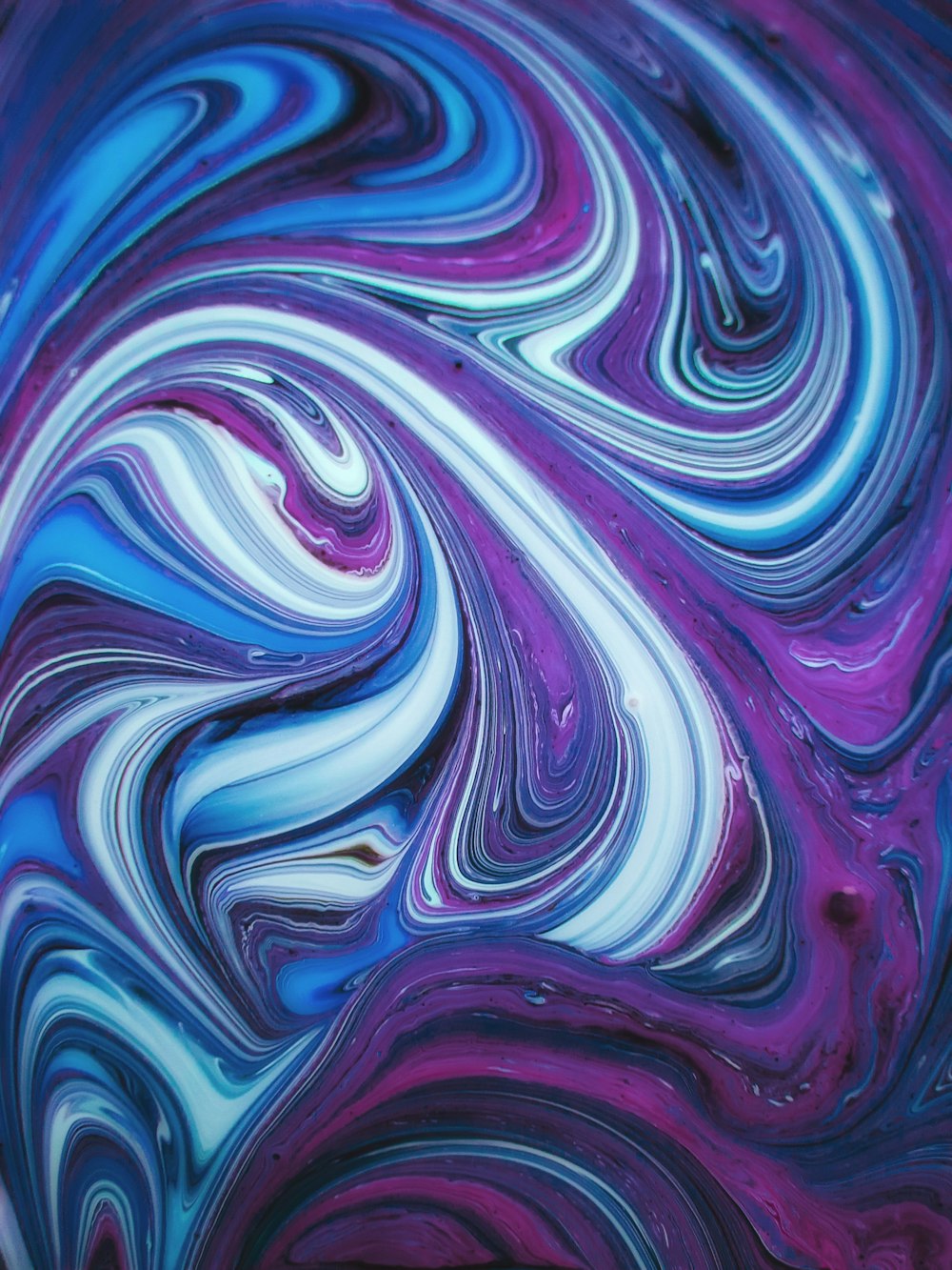a close up of a purple and blue swirl