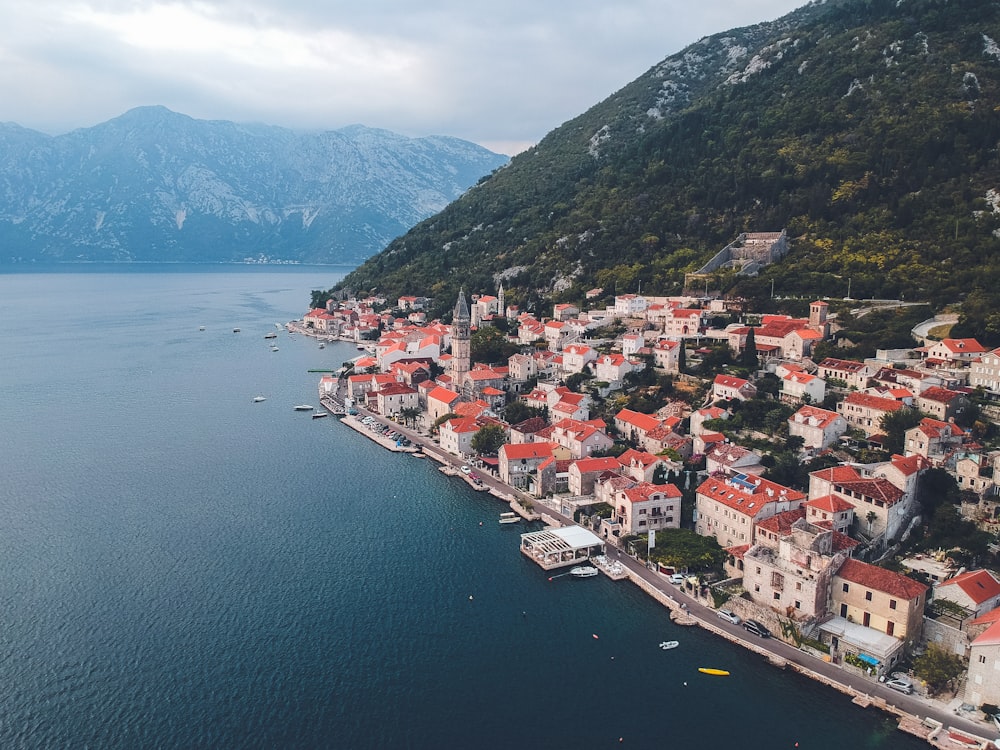 an aerial view of a small town on the shore of a lake