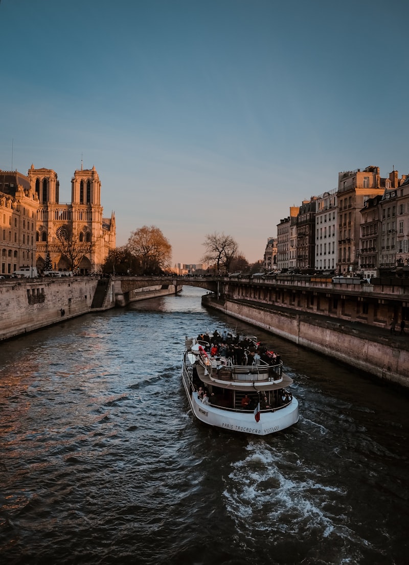 Seine river with boat and Eiffel Tower at sunset