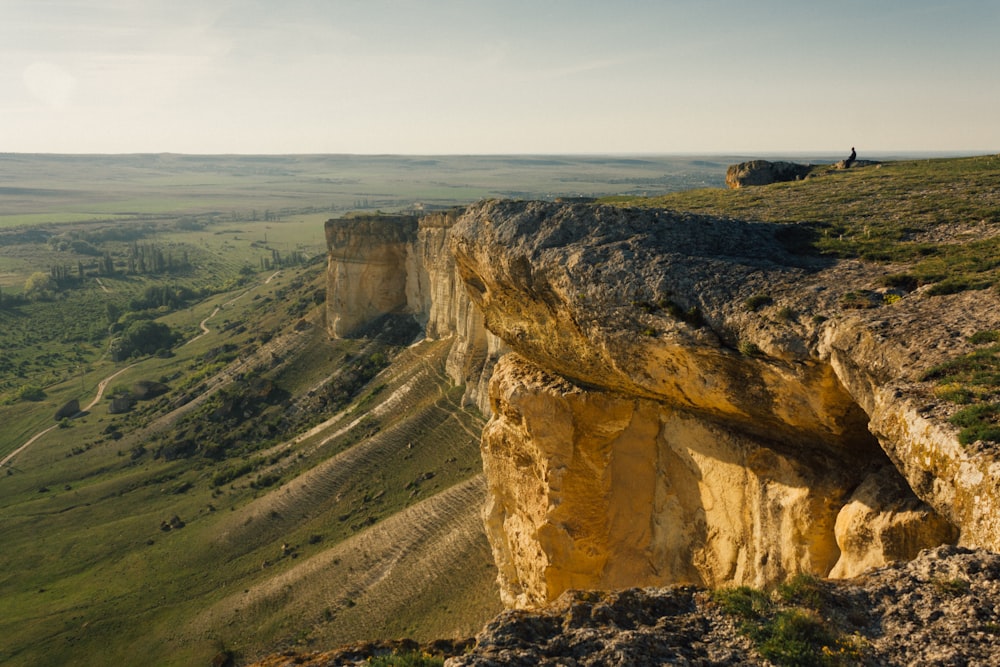 a person standing on top of a cliff