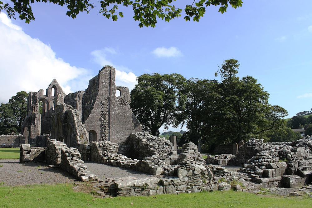 a large stone building sitting on top of a lush green field