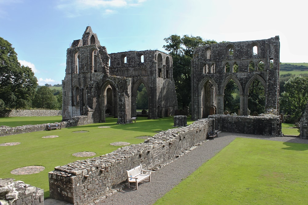 a stone building with a bench in front of it