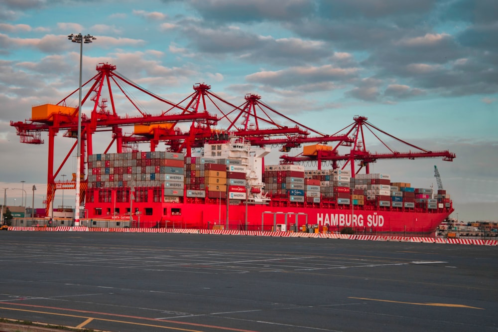 a large red container ship sitting in a harbor