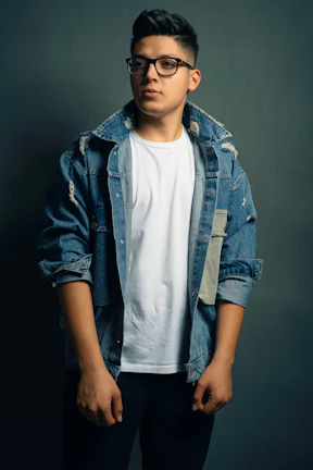 A modern outfit combining a chic jacket with casual jeans, showcased on a minimalist dark background.