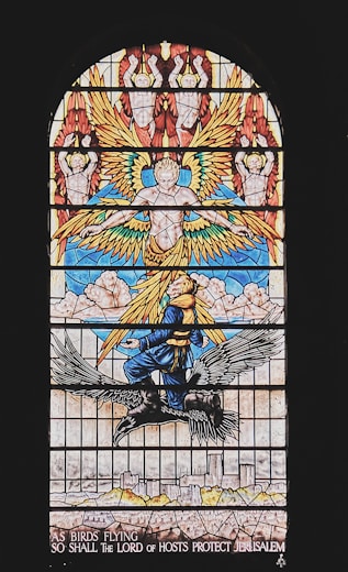 a stained glass window with an angel on it