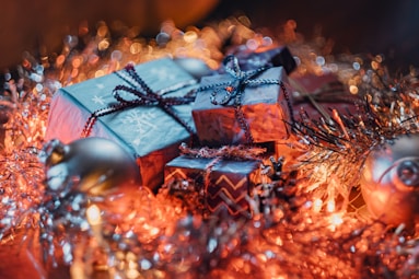 a pile of wrapped presents sitting on top of a table