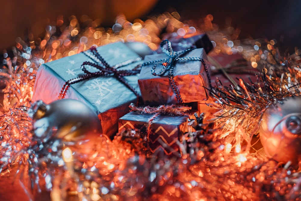 a pile of wrapped presents sitting on top of a table