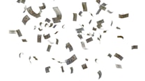 Hundred dollar bills are floating and scattered in mid-air against a plain white background. The money appears to be in motion as if being blown by the wind.