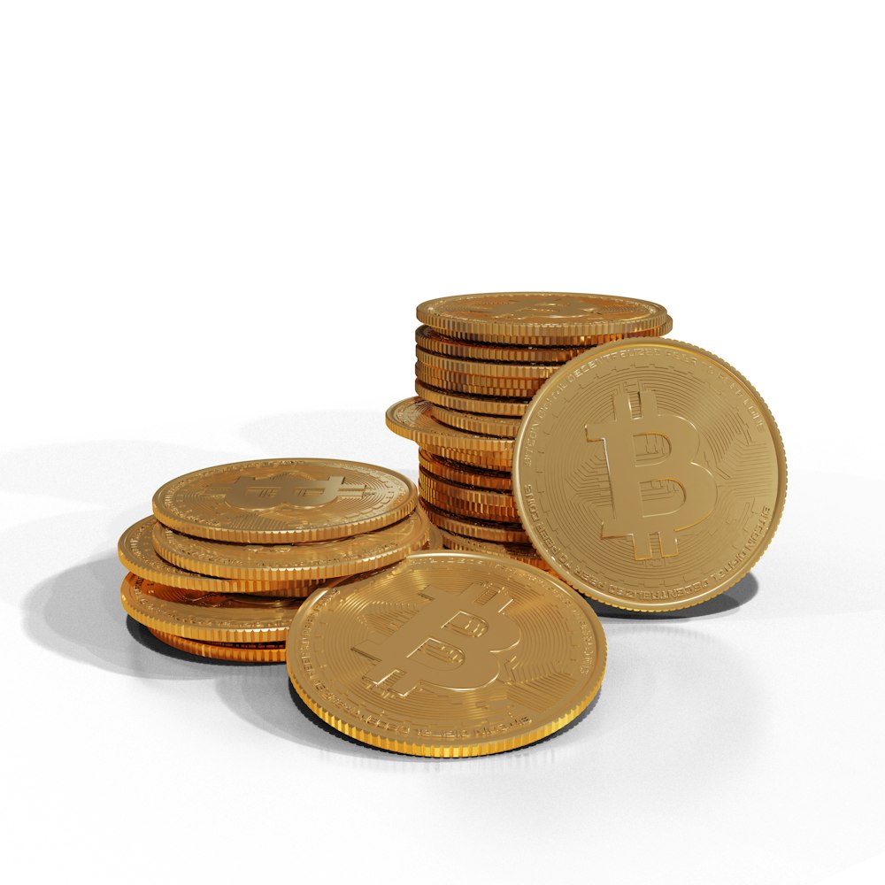 a pile of gold bitcoins sitting on top of each other