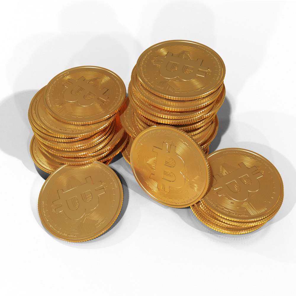 a pile of gold bitcoins sitting on top of each other