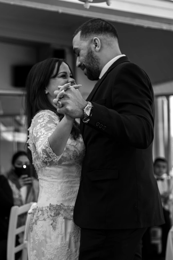 a bride and groom feeding each other cake