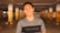a man standing in a parking garage smiling