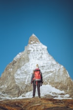 a man standing on top of a snow covered mountain