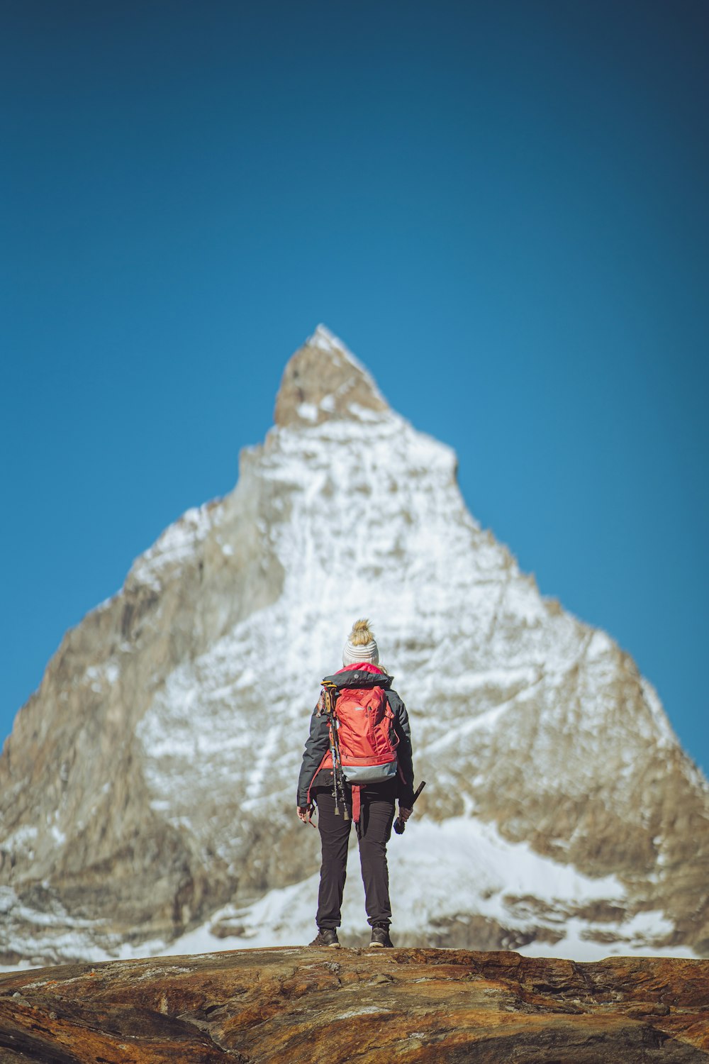 a man standing on top of a snow covered mountain