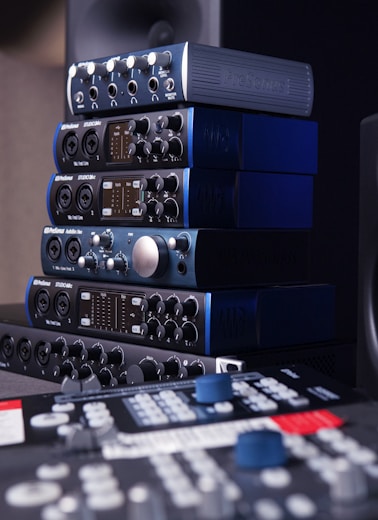 a stack of sound equipment sitting on top of a table