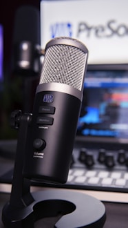 a microphone sitting on top of a desk next to a laptop
