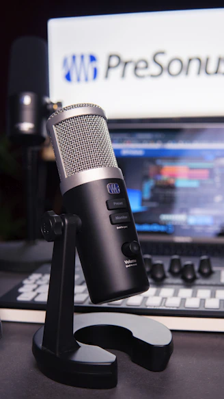 a microphone sitting on top of a desk next to a laptop