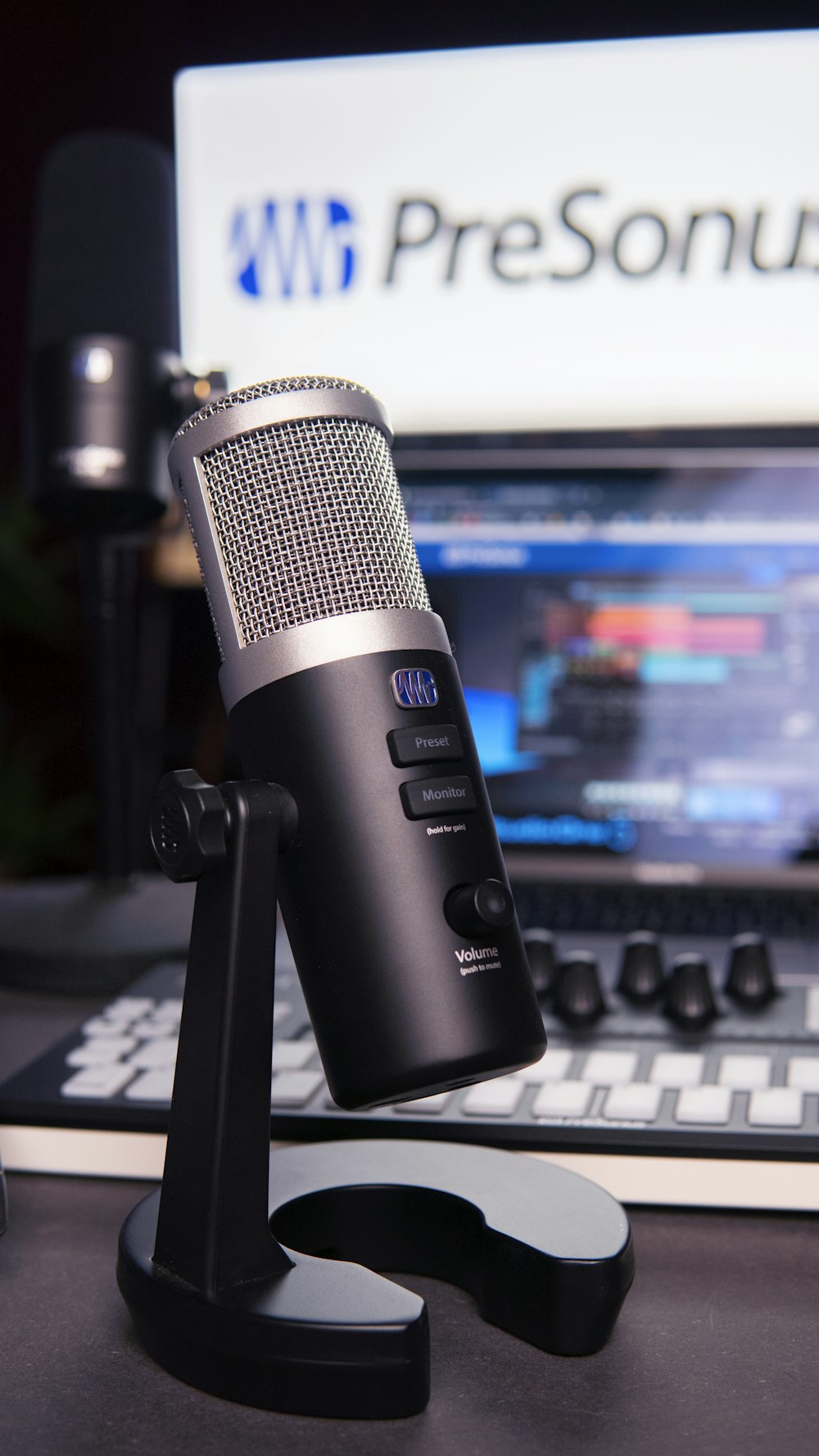 a microphone sitting on top of a desk next to a laptop