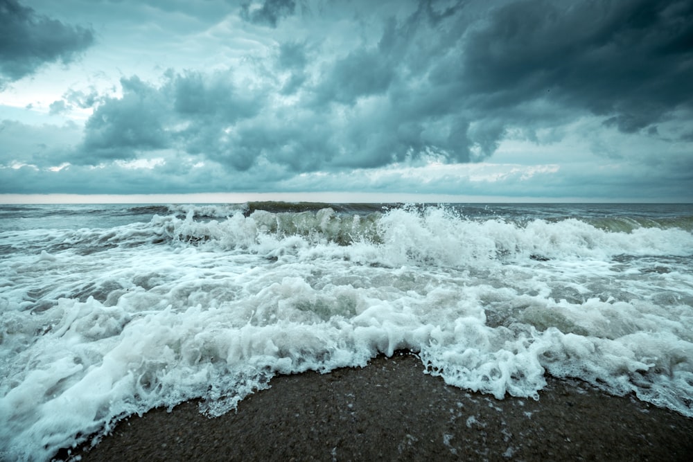 a large body of water with waves crashing on top of it